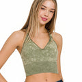 Woman wearing a green sports bra on a white background